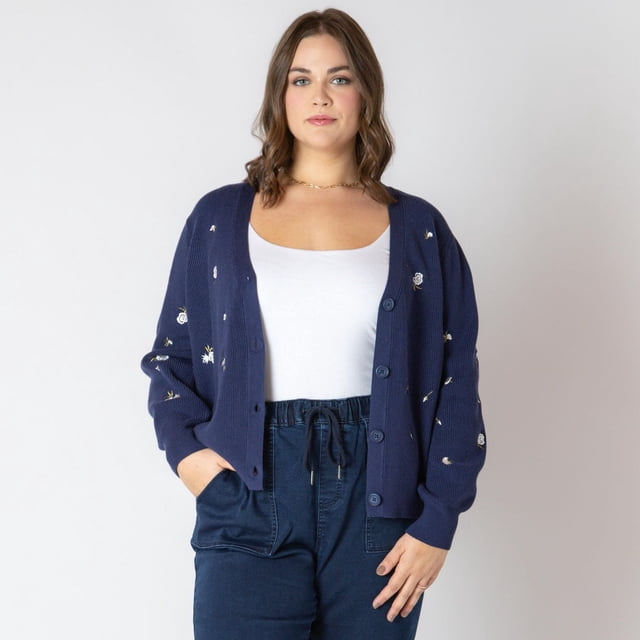 Devoted Women's Plus Size long sleeve knit cardigan with button-up front in navy blue featuring embroidered white floral details, worn open over a white camisole and paired with navy drawstring pants, shown in a centered front-facing view on a plain light background, ideal for layering on cooler nights or wearing unbuttoned on warmer days.