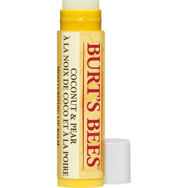 Burt’s Bees 100% Natural Moisturizing Lip Balm, Coconut & Pear, shown in a close-up front view with the balm stick extended. The yellow cylindrical tube features a label with red Burt’s Bees branding and bilingual text describing the coconut and pear flavor. This hydrating lip care product nourishes lips naturally and is ideal for daily moisturizing.