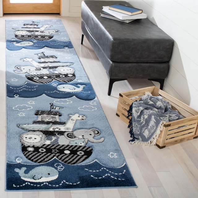 Safavieh Carousel Kids Patton Animals on Board Area Rug is a durable kids runner rug featuring storybook animals like elephants, whales, and giraffes on boats in muted pastel blues and greys, power-loomed synthetic yarn for lasting colour, placed on light hardwood floor beside a dark grey bench and wooden crate with a blue throw.