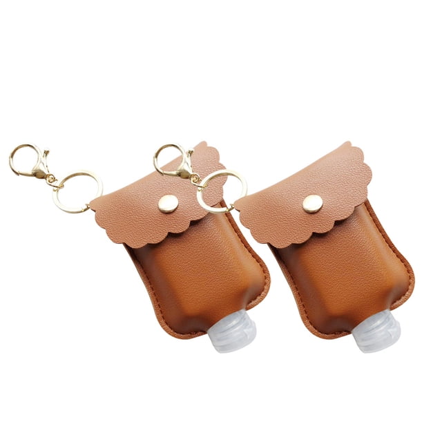 Dvkptbk Hand Sanitizer Packet Portable Disposable Pouch Outdoor Key Holster 2Pcs Travel Equipment. Two brown double-sided leather pouches with scalloped flap closures, each featuring a gold keychain clip and holding a refillable 30 ml bottle with a flip cap. Compact and ideal for carrying hand sanitizer, shampoo, or lotion during travel or outdoor activities.
