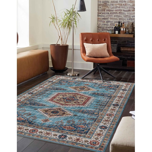 ECARPET Tracy Traditional Area Rug with a blue background and grey outer border featuring antique-style geometric patterns in red, beige, and brown. Made of durable polyester, it is placed on dark hardwood flooring in a living room with a brown leather swivel chair with beige pillow, tall potted plant, floor lamp, and brick accent wall with shelves holding bottles and decor, ideal for high-traffic areas.