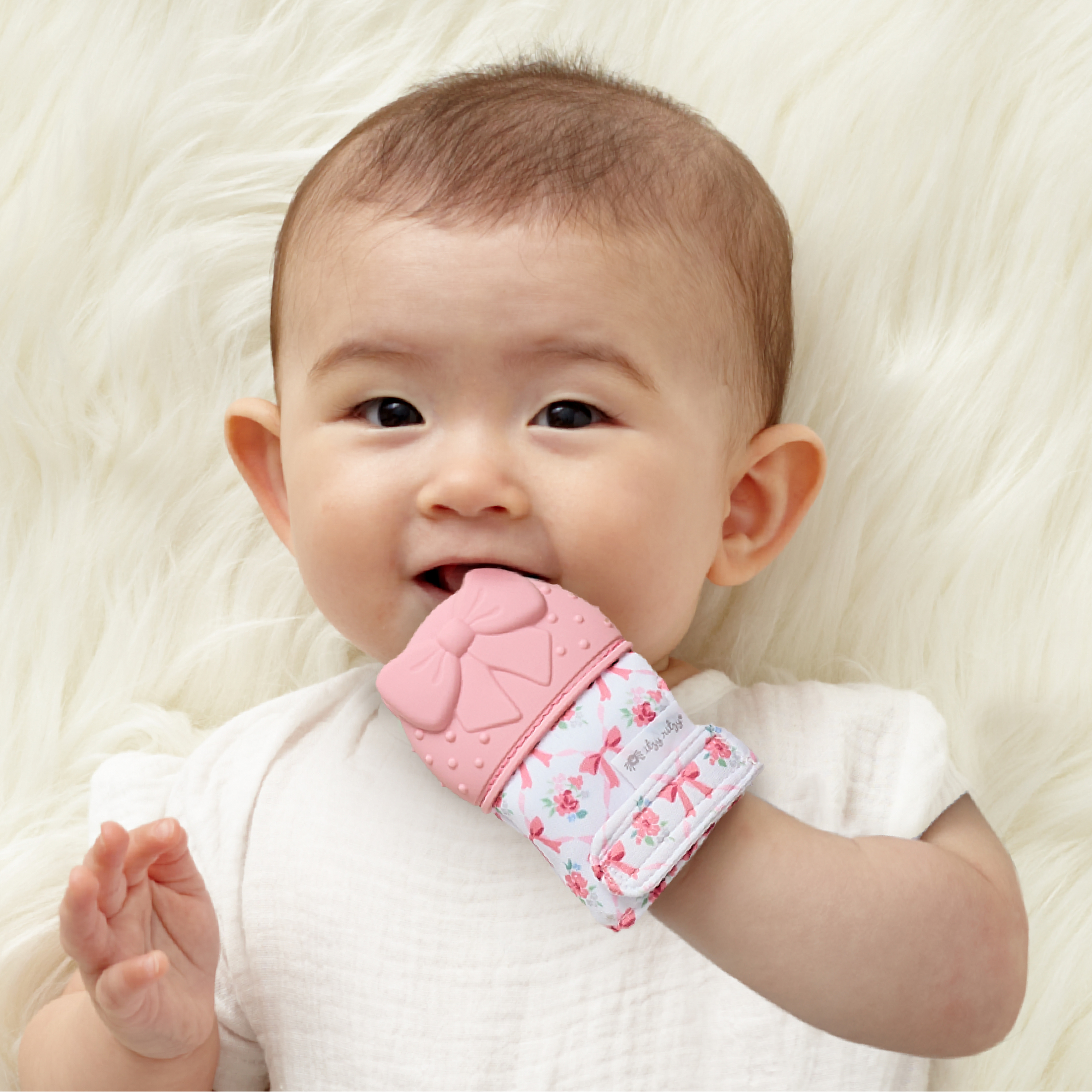 Itzy Ritzy Itzy Mitt™ Bow Silicone Teether for Infants, 0+ Months
