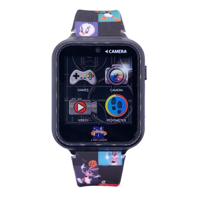 Space Jam Touch Screen Interactive Watch with Camera featuring a black square plastic case and digital touchscreen displaying icons for games, camera, video, and pedometer. The adjustable strap shows colorful Space Jam characters including Bugs Bunny and Tweety Bird on a black background, ideal for children aged 6 and up.