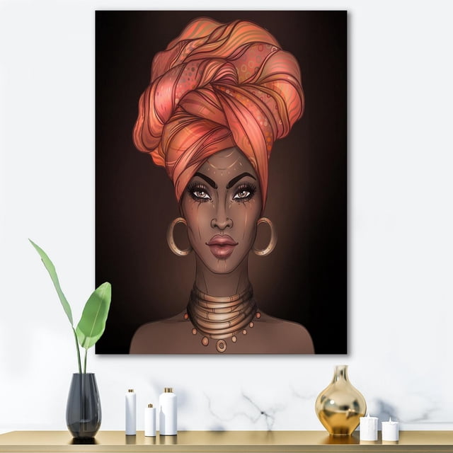 Designart African American Woman with Turban V Canvas Wall Art depicting a modern portrait of a woman wearing a large orange patterned turban, gold hoop earrings, and layered necklaces on a dark background, gallery-wrapped on premium cotton canvas and ready to hang.