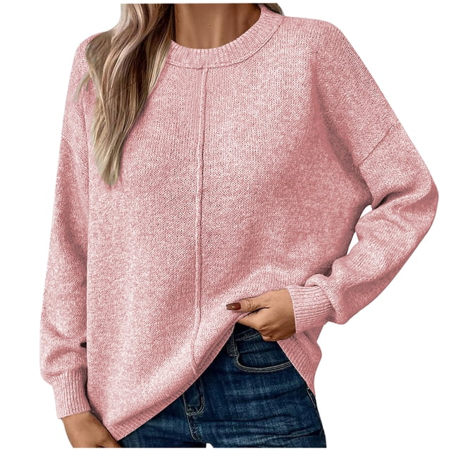 Timegard women's sweater featuring a crewneck design and long sleeves, shown in a soft pink solid color. The knit pullover has a casual, loose fit with clean lines and a simple silhouette, ideal for fall and winter layering. Styled with blue jeans, the sweater offers a relaxed and comfortable look.