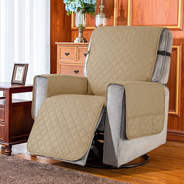 Subrtex Reversible Recliner Chair Cover Washable Furniture Protector in a sand color, displayed on a recliner in a cozy living room setting. The cover features a quilted design, side pockets for storage, and adjustable straps to secure it in place. Made of 100% microfiber fabric, it is soft, durable, and protects against spills, stains, and wear. Suitable for recliners with seat widths of 25 inches (small) or 28 inches (large).