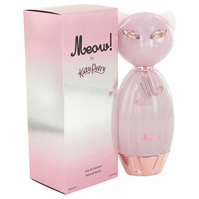 Meow By Katy Perry Eau De Parfum Spray 3.4 oz, presented in a whimsical pink cat-shaped bottle with rose gold accents. The fragrance box is pink and silver, featuring the Meow by Katy Perry branding. This perfume for women offers a blend of tangerine, pear, jasmine, gardenia, lily of the valley, and orange blossom for a sweet and alluring scent.