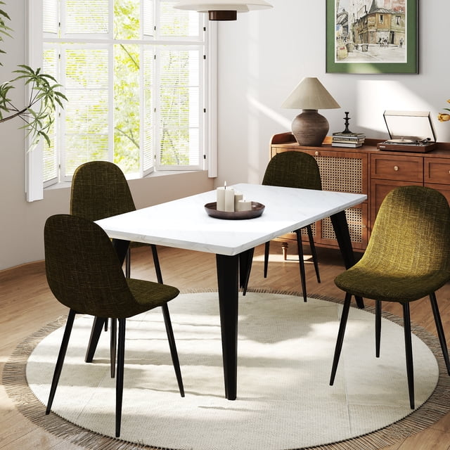 Homy Casa 63 inch Dining Set for 4 with a rectangular faux marble tabletop featuring seamless vacuum-formed edges and black tapered flat iron legs with adjustable foot pads. Includes four padded chairs with curved backs and dark fabric upholstery, arranged on a round beige fringed rug in a bright dining room with wooden flooring, a sideboard with a lamp, books, and framed artwork. Suitable for kitchens, dining rooms, or apartments seeking modern functional style.