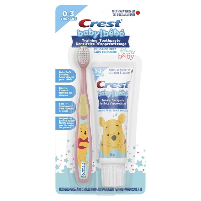 Crest Training Toothpaste Kit, Fluoride Free, Mild Strawberry Gel Toothpaste 36 mL with a baby soft bristle manual toothbrush featuring Disney Winnie the Pooh, designed for babies 0-3 years to gently clean teeth and gums, safe if swallowed and recommended by pediatricians.
