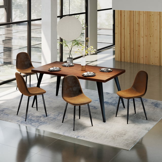 Homy Casa 63 inch Dining Set for 4 with a rectangular faux walnut wood table featuring black flat iron legs and adjustable foot pads, accompanied by four brown fabric-upholstered chairs with curved backs and black metal legs, placed on a neutral area rug in a bright dining room with large windows and wood panel walls, ideal for kitchens or apartments.
