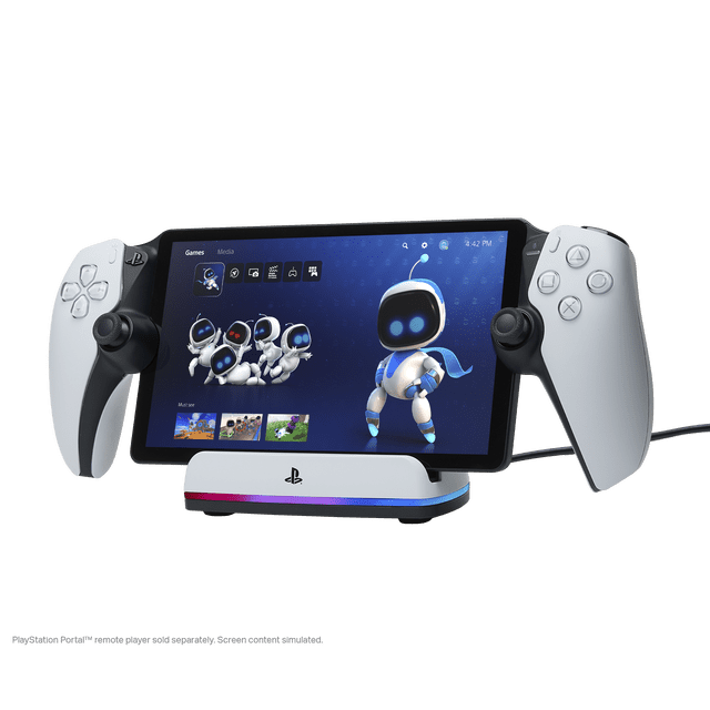PowerA Charging Station for PlayStation Portal™ Remote Player with Lumectra™ showing the PlayStation Portal remote player docked on the white charging station with a weighted base and RGB lighting. The remote player screen displays animated robot characters on a blue interface, flanked by white detachable controllers with black thumbsticks. The station includes a USB-C cable for connection and charging, providing stable display and easy docking.