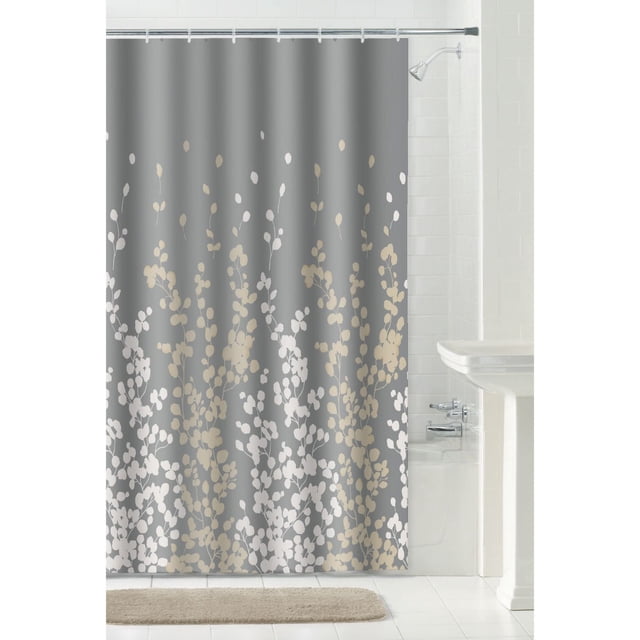 Mainstays Decorative Shower Curtain with 12 Hooks: 13 Piece Shower Set in grey fabric featuring beige and white botanical leaf patterns, measuring 70 by 72 inches, hanging in a white tiled bathroom with bathtub and pedestal sink, ideal for standard shower or tub areas.