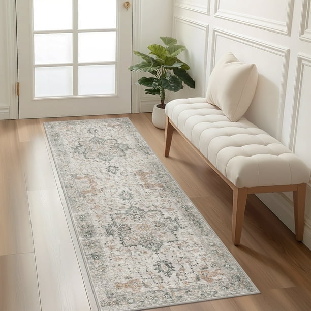 KUETH 2'x10' machine washable rug displayed in a bright entryway with a tufted bench and potted plant. The ultra-thin, non-slip runner rug features a vintage-inspired blue and gray abstract pattern on a low-profile polyester surface, ideal for high-traffic areas like hallways or bedrooms. Its rubber backing ensures stability on hardwood floors.