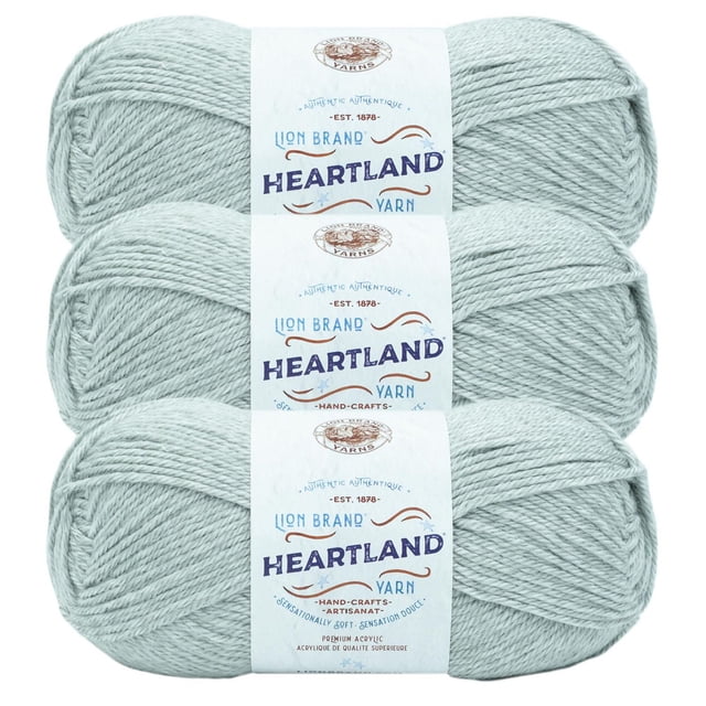 Lion Brand Yarn Heartland Yarn 3Pack with three skeins of light grey worsted weight acrylic yarn stacked vertically, featuring white labels with blue and brown text and lion logo, machine washable and durable, ideal for knitting and crochet projects.