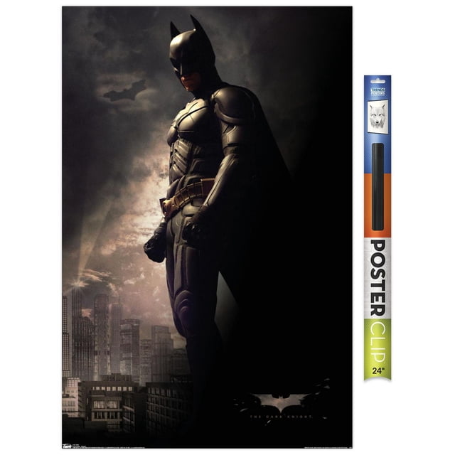DC Comics Movie - The Dark Knight - Batman in the Shadows Wall Poster, 22.375" x 34" showing Batman in a black armored suit and cape standing in profile against a dark city skyline with the Bat-Signal shining in the cloudy sky, suitable for decorating bedrooms, offices, or dorms.