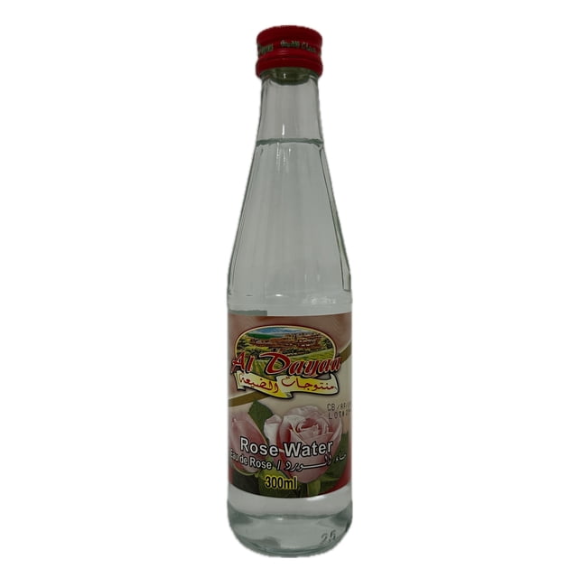 Al Dayaa Rose Water 300ml clear glass bottle with red cap, featuring a label with pink roses and Arabic and English text, used as a floral facial toner and skin care product ideal for refreshing and toning skin.