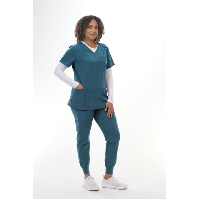 Greentown Canada Scrubs Top (Zinnia 6218-1074) in teal blue with V-neck and short sleeves, featuring seven functional pockets including a pen pocket on the sleeve and a zippered side pocket, made from wrinkle-resistant, fast-drying four-way stretch fabric, shown with matching jogger-style scrub pants and white sneakers suitable for medical workwear.