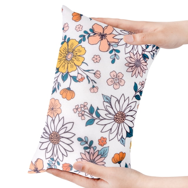TopLLC Small Pillow For Kids, a compact travel pillow with a floral print, shown being held in hands. Measuring 11 x 7 x 2.5 inches, it is lightweight and portable, perfect for car or airplane travel. Made with soft, breathable fabric, it includes a name tag for personalization. Designed for neck, back, and lumbar support, it is also suitable for kids' play and sleep. Vacuum-packed for shipping convenience.