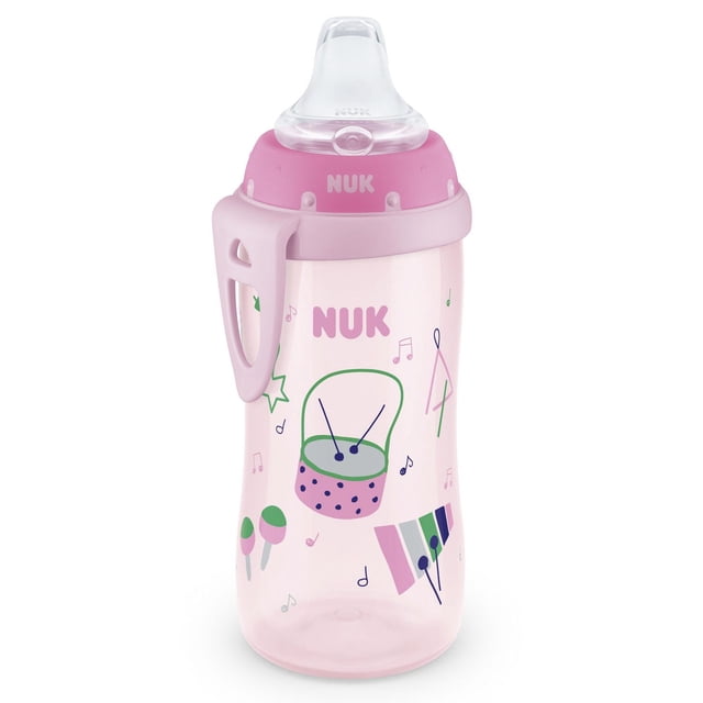 NUK Active Sippy Cup, Pink, 10 oz, translucent pink toddler cup decorated with colorful musical instruments including a drum, maracas, and xylophone, featuring a soft spill-proof spout, pink lid with NUK logo, and a pink carrying clip, designed to help toddlers transition from bottle to cup.