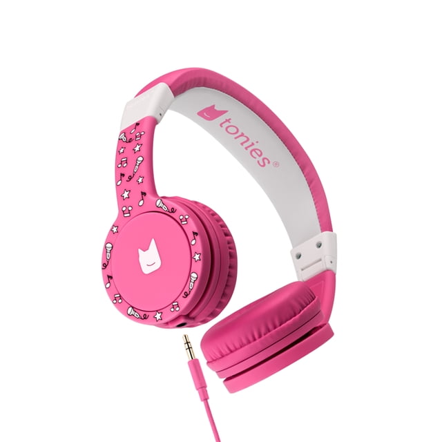 Tonies Headphones – Pink over-ear kids headphones with adjustable padded headband and cushioned earpads, foldable design for travel, decorated with white music notes, stars, and microphone icons on the ear cups, featuring a 3.5mm detachable cord and tonies logo inside the headband, designed for safe listening at 85 dB.