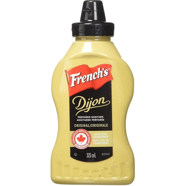 French's Dijon Mustard 325ml squeeze bottle with black flip-top cap containing yellow prepared mustard, label features red French's logo, Dijon script, Canadian maple leaf emblem for Canadian mustard seeds, and Chardonnay ingredient, often used to add flavour to sandwiches and dressings.