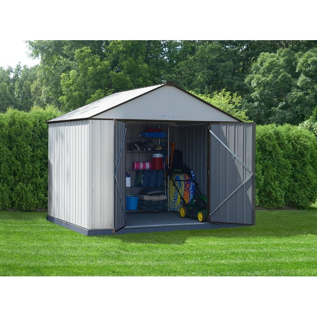 EZEE Shed Steel Storage 10 x 8 ft. galvanized metal shed with extra high gable cream panels and charcoal trim, front view with open double swing doors revealing interior metal shelving with outdoor gear and a lawn mower on green lawn surrounded by trees, suitable for organized outdoor storage