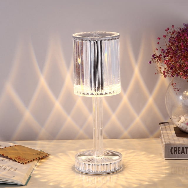 RXIRUCGD Home Decor Gifts Touching Control Crystal Lamp, a cordless table lamp with a diamond-shaped acrylic crystal design. Features a 3-way dimmable LED light, touch control on the base, and a USB port. Emits soft white light with elegant rainbow refractions and intricate shadows. Ideal for bedside or nightstand use.