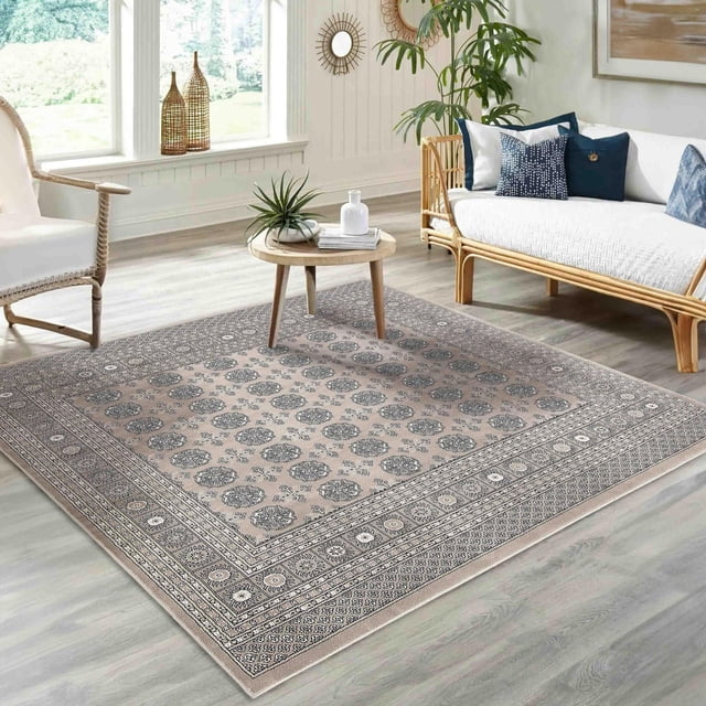 ECARPET Traditional Area Rug in grey featuring a classic Oriental Bokhara geometric pattern with a soft, dense, and durable pile, placed in a bright living room with light wood flooring, rattan sofa with white cushions, and a round wooden coffee table with decorative plants, ideal for adding timeless style to high-traffic modern homes.