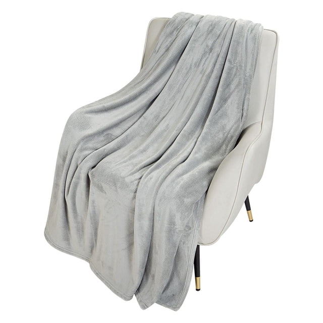 HOMETRENDS Luxury Plush Blanket in grey draped over a cream armchair, made from soft mid-weight microfibre with a ribbed texture, designed for warmth and everyday use in bedding and throws, also suitable for cozying up on the couch.