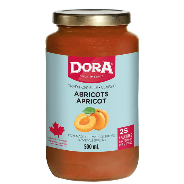 Dora Apricot Traditional Light Spread in a 500 mL clear glass jar with gold metal lid, featuring a light blue label with apricot fruit illustration and Canadian maple leaf, gluten-free vegan jam-style spread with 25 calories per serving, suitable for breakfast toast or cheese platters.