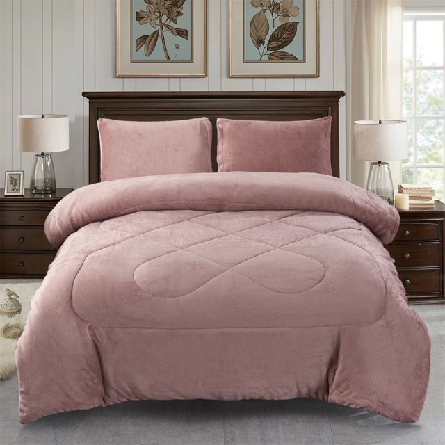 Jin Mai Lan Solid Woodrose Sherpa Fluffy Reversible Washable Bed Blankets, Full Queen, Pink, 3-Pieces. The image shows a soft pink Sherpa blanket set displayed on a neatly made bed in a cozy bedroom setting. The set includes a reversible Sherpa blanket with a quilted design and two matching sham pillows. The blanket is made of 100% polyester microfiber, offering a super soft and fluffy texture. The room features a wooden headboard, bedside tables with lamps, and floral wall art, creating a warm and inviting atmosphere.