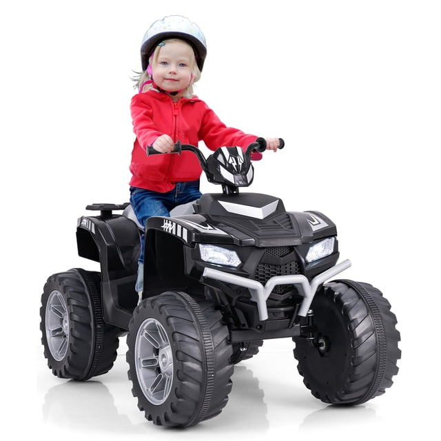 Gymax Kids Ride-On ATV 24V Battery Powered Electric Vehicle in black, featuring large tread tires, LED headlights, and a sturdy design. A child wearing a helmet is seated on the ATV, showcasing its spacious seat and anti-slip handles. The vehicle includes a multi-functional center console with a USB port, wireless connection, and music/radio options. Designed for children aged 3-8, it offers high and low-speed settings, a soft start for safety, and up to 2 hours of playtime. Suitable for various terrains like cement, asphalt, and brick roads.