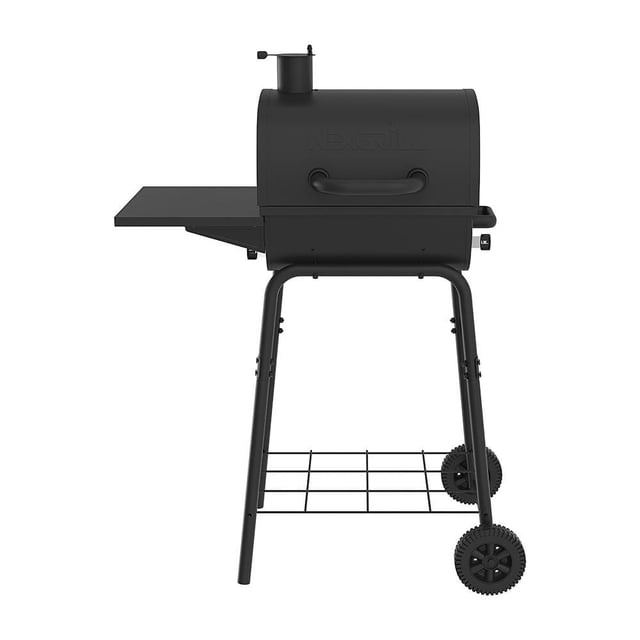 17.5 Inch Barrel Charcoal Grill in Black with a matte black steel barrel, chimney vent, left side shelf, two wheels for mobility, and a lower wire rack for charcoal storage, designed for outdoor BBQ cooking.