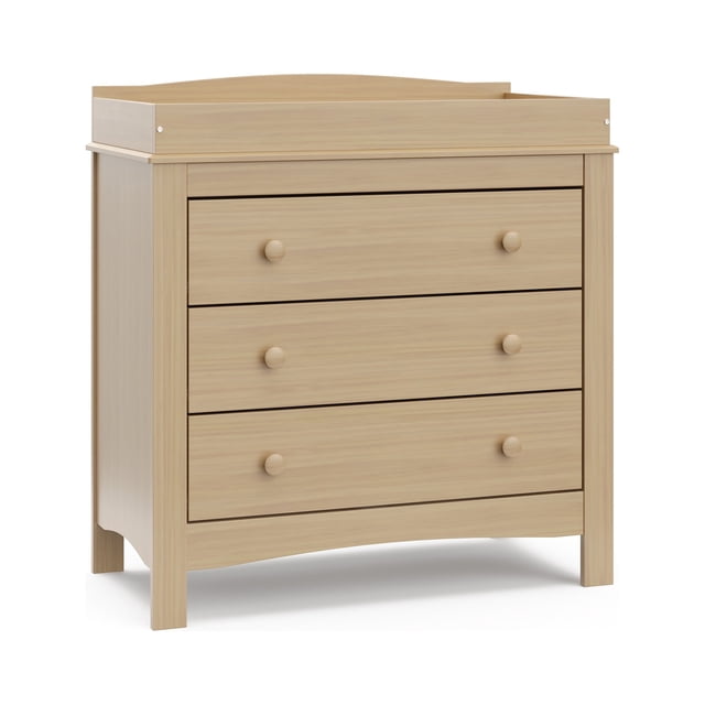 Graco Noah Commode à 3 Tiroirs avec Dessus à Langer en Fini Stratifié Bois Clair, Comprenant Trois Tiroirs Spacieux avec Boutons Ronds en Bois et un Dessus de table à Langer Amovible, Conçue pour les Meubles pour Enfants avec Système de Tiroirs de Sécurité Emboîtable et Trousse Anti-Basculement.