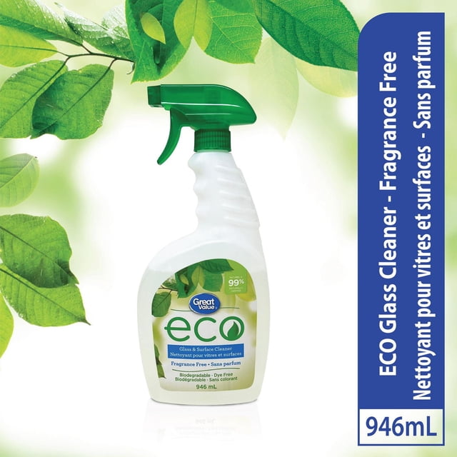 Great Value ECO Fragrance Free Glass and Surface Cleaner in a 946 mL white spray bottle with green trigger, biodegradable and dye free, formulated for streak-free cleaning of windows and mirrors, shown with green leaves to emphasize eco-friendly qualities.