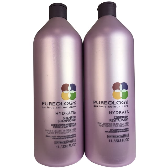 ($138 Value) Pureology Hydrate Shampoo and Conditioner Liter Set, 33.8 Fl Oz. This set includes two lavender-toned bottles, one for shampoo and one for conditioner, designed for dry or color-treated hair. The bottles feature the Pureology logo and details about the sulfate-free formula with AntiFade Complex for color vibrancy. Suitable for moisturizing and strengthening hair with ingredients like jojoba, green tea, and soy proteins. Aromatherapy blend of ylang-ylang, bergamot, and patchouli enhances the experience.