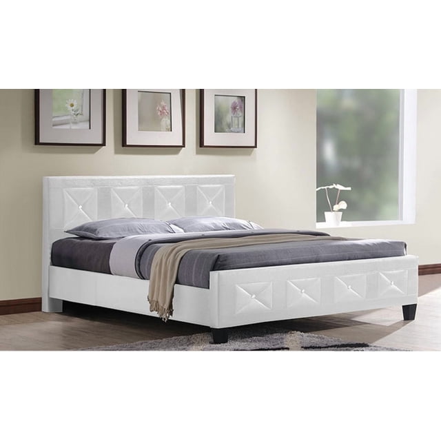 Aerys Crystal Tufted Upholstered Double Bed in white, shown in a front 3/4 view with a padded faux leather headboard and footboard featuring crystal tufted details. This platform bed has a solid wood frame and requires no box spring. It is dressed with gray bedding and a beige throw, set in a minimalist bedroom with light walls, three floral framed artworks above, and a window with a potted plant on the sill.