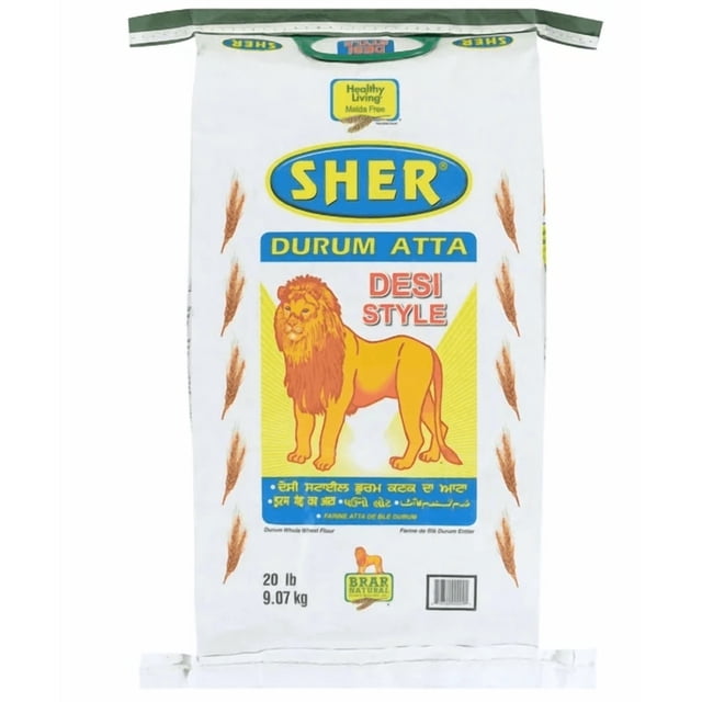 Sher Desi Durum Flour - W 20 lb (9.07 kg) bag of whole wheat flour made from hard durum wheat in desi style, featuring a white sack with a yellow lion graphic and blue Sher logo. This flour is rich in fiber and nutrients, ideal for making soft, fluffy Indian breads like roti, chapati, and paratha.