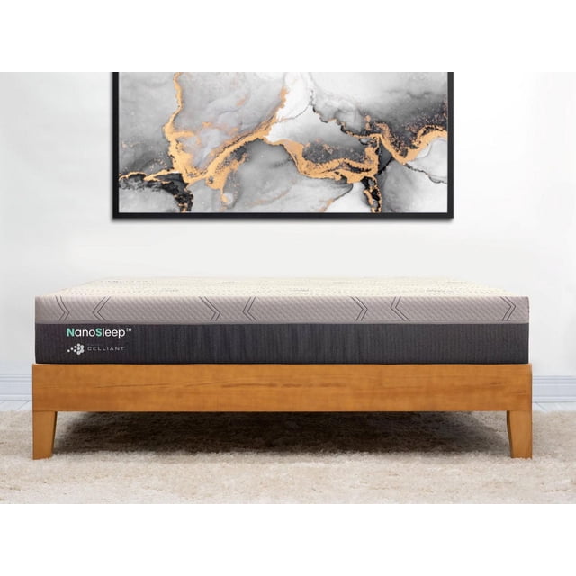 NSC Medical NanoSleep™ 10 in Foam Mattress - Twin on a wooden bed frame with a light beige quilted top and dark gray sides featuring NanoSleep and Celliant logos, set beneath abstract gray and gold wall art in a minimalist room.