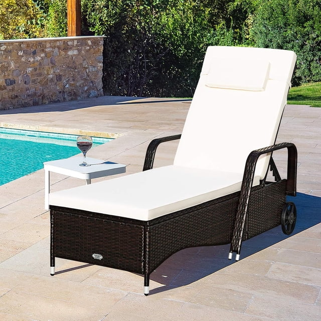 Gymax Chaise Lounge d'Extérieur en Osier Coussinée avec Dossier Réglable et Roues, Fabriquée en Rotin PE Brun durable et Dotée de Coussins Blancs Épais. Idéale pour les Meubles de patio, les Sièges Extérieurs Ou la Détente au Bord de la Piscine, Montrée sur un patio Ensoleillé avec une Petite table d'Appoint et un Verre d'Eau à Proximité.