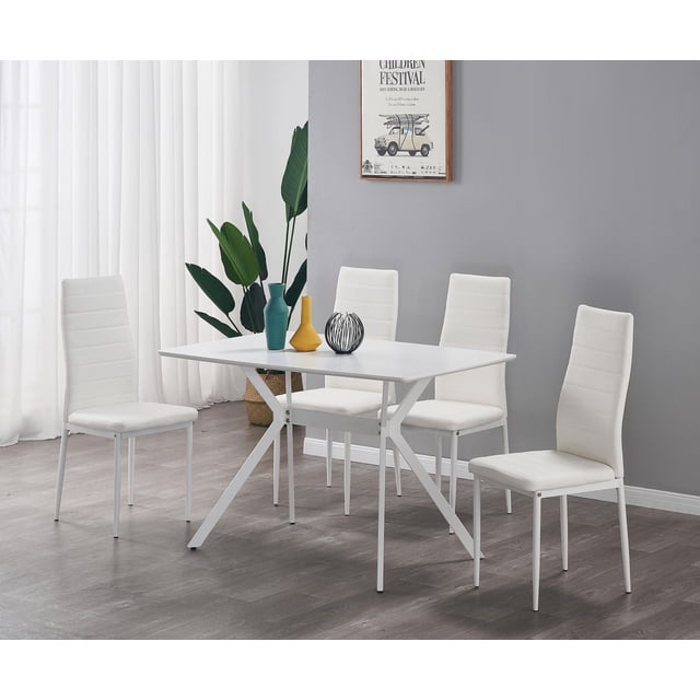 FURNITURE NASH DINNING SET-WT with a white rectangular dining table featuring anti-scratch powder-coated metal legs and four white PU upholstered chairs with metal frames, arranged in a bright room with gray walls, sheer curtains, and decorative vases on the table, suitable for compact dining spaces.