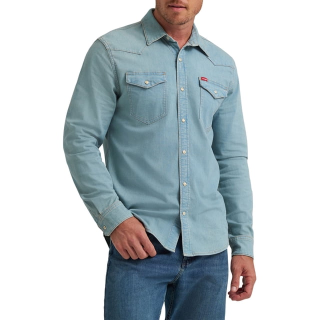 Wrangler® Men's Long Sleeve Denim Shirt in light blue cotton blend with snap closure, straight back yoke, two chest flap pockets, and hidden sunglass cleaner at the hem, worn by a male model paired with blue jeans.