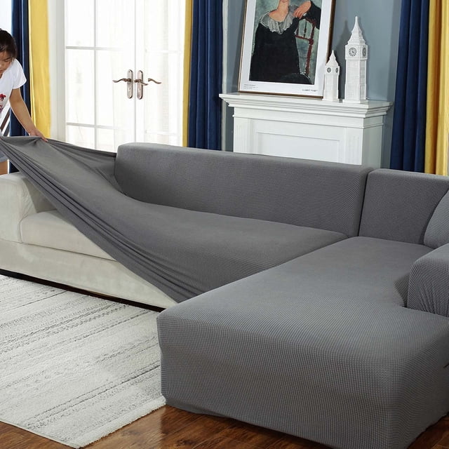 Stretch durable L shape sofa cover for 2-seaters in light gray, made of thick polyester and spandex fabric. This slipcover is textured for a comfortable feel and aesthetic look, designed to protect furniture from stains, spills, and wear. Features include silicone dots on the back for anti-slip, wide twine cords to secure the cover, and anti-slip buckles at the seams. Easy to install and machine washable, ideal for homes with kids and pets.