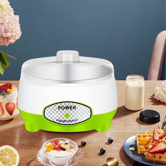 LSLJS Yogurt Maker Machine, a compact and automatic household appliance with a green and white ABS and stainless steel design. The yogurt maker is shown on a wooden table surrounded by breakfast items like yogurt bowls, waffles, and fruit. It features a 1L capacity, BPA-free materials, and a microcomputer control system for consistent heating. Ideal for making yogurt, rice wine, natto, and other fermented foods. The machine is energy-efficient with an automatic shut-off after 10 hours.