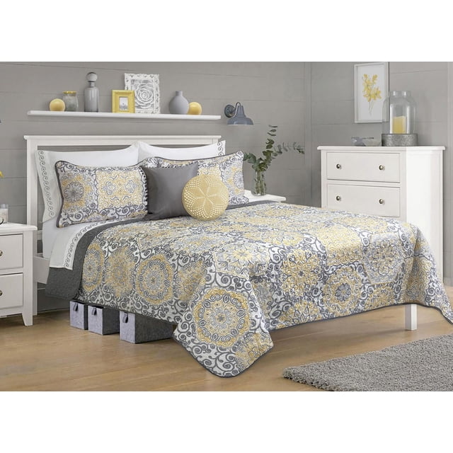 Safdie & Co. Quilt Set 2PC T Jensen featuring a grey and yellow medallion pattern comforter and matching pillow sham on a white wooden bed frame. The 66x86 inch comforter and 20x30 inch sham are made from soft 100% polyester microfiber, adding warmth and subtle elegance to any bedroom. The set is ideal for layering with other bedding for enhanced comfort and style.