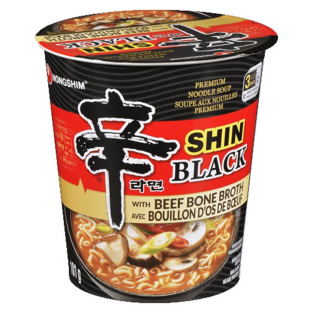 Nongshim Shin Ramyun Black Cup with black and red packaging featuring bold Korean characters and text emphasizing beef bone broth, showing noodles with mushrooms and green onions on the label, designed as an instant soup with dehydrated vegetables for pantry food use.