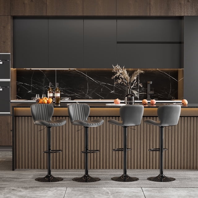 Walsunny Adjustable Bar Stools Set of 4 with black leather upholstery, swivel counter-height seats, and large bases. Positioned in a modern kitchen with marble countertops and wooden paneling, these stools feature a scalloped ergonomic design for comfort. The adjustable height and 360-degree swivel provide versatility, while the water-resistant faux leather ensures easy cleaning. Suitable for home kitchens, bars, or restaurant seating.
