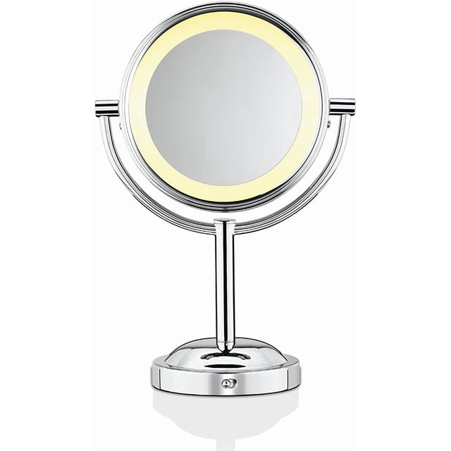 Conair True Glow 1x/5x Soft Halo Makeup Mirror with polished chrome finish, featuring a round double-sided mirror with lifetime LED halo lighting and dual 1x and 5x magnification, mounted on a swivel pedestal base for adjustable angles, battery operated for cordless use.