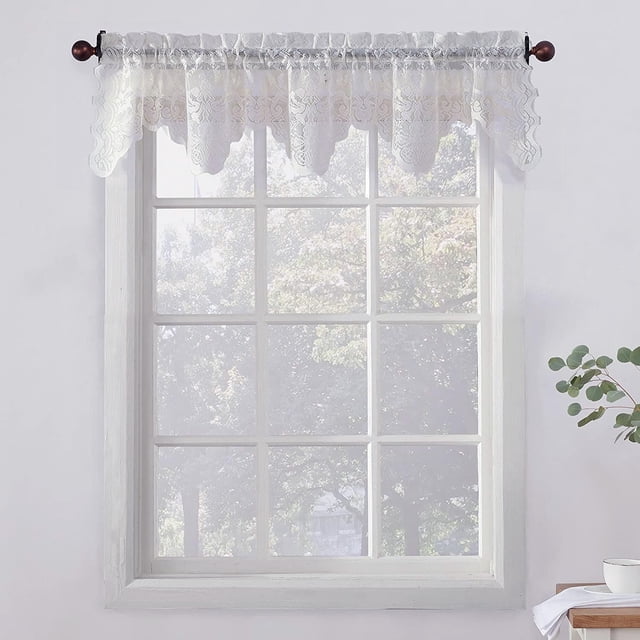 SUN TEXTILE Floral Sheer Lace Kitchen Valance with jacquard floral lace and scalloped edges, hanging on a wooden rod above a white window frame, softly filtering light and enhancing privacy, machine washable and made of 100% polyester, often used as a decorative accent in kitchen window coverings.