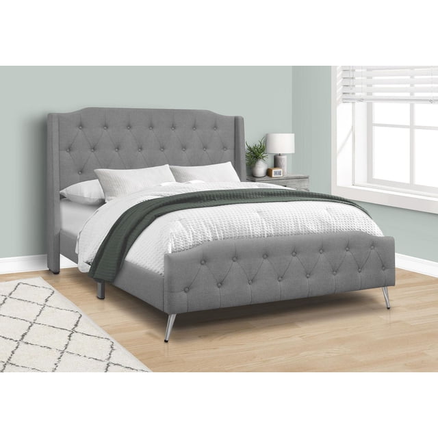 Monarch Specialties Bed, Queen Size, Platform, upholstered in grey linen-look fabric with button tufting on the wingback headboard and curved footboard, featuring chrome slanted metal legs and fabric-covered support feet, placed on a light wood floor near a window and nightstand in a bedroom. Suitable for standard queen size box spring and mattress (not included).